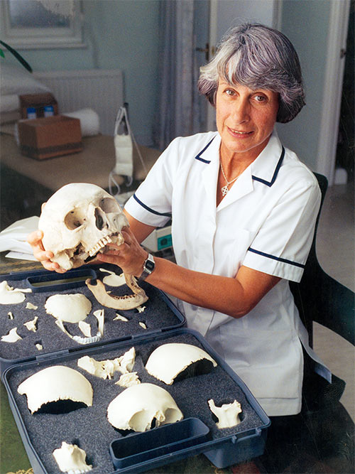 Myra at her practice showing a set of skulls used in teaching Craniosacral  Therapy 